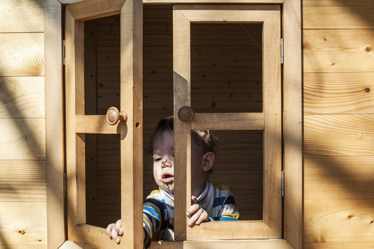 Baby Boy Playing In The Wooden House For Kids