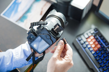 Photographer puts the memory card in his camera