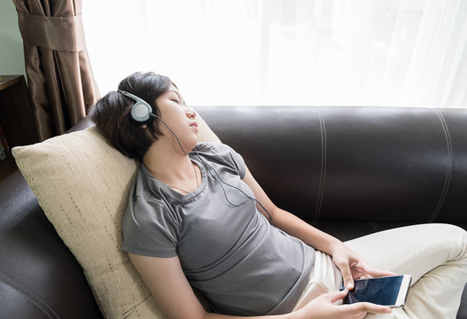 Young asian woman short hair listening music