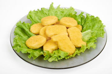 chicken nuggets and vegetables on a white plate, isolated on white