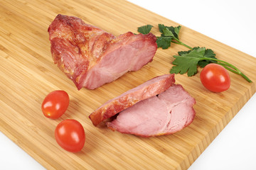 Cooked sliced pork barbecue steak on wooden cutting board on the white background