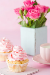 Pink pastel vertical banner with decorated cupcakes, cup of coffe with milk and bouquet of pink roses.