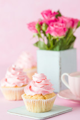 Pink pastel vertical banner with decorated cupcakes, cup of coffe with milk and bouquet of pink roses.