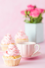 Pink pastel vertical banner with decorated cupcakes, cup of coffe with milk and bouquet of pink roses.
