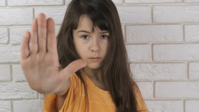 Child abuse. Domestic violence. Stop gesture. The child shows a gesture to stop.