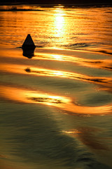 Reflection of the sunset on the watery surface.