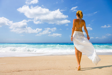 Fototapeta na wymiar Woman on the wild beach of the island of Lefkada