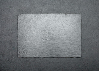 decorative stone serving board on concrete background