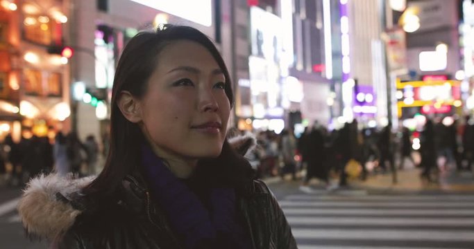 Japanese female on street at night, Tokyo, Japan