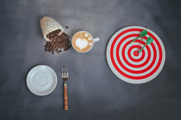 hot late art with coffee beans and dart board on background.