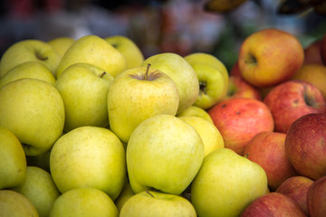 Green and red apples at the food market