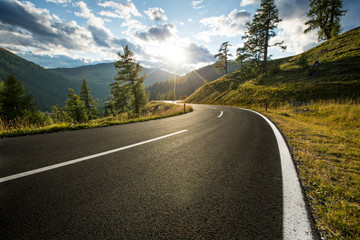 Asphalt road in Austria, Alps in a summer day. - Powered by Adobe