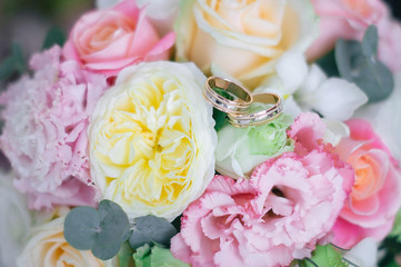 Close up of colorful spring wedding with wedding rings on it