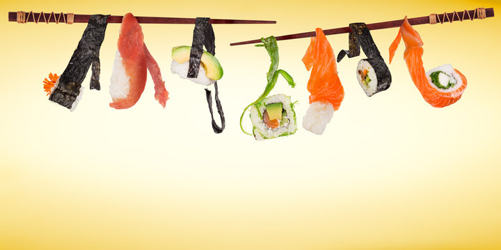 Pieces of delicious japanese sushi frozen in the air.