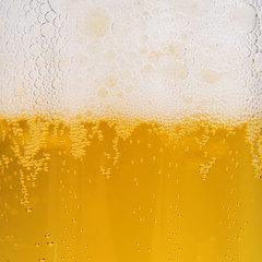 Close up of beer bubbles with froth, beer background