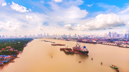 Aerial view of landscape a cargo ship parked in the river. Rice husk grader loading and unloading...