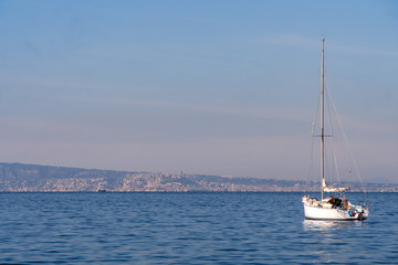 Obraz premium Small yaht in the sea, Napoli at background, Sorrento Italy