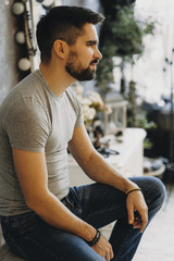 Side view portrait of a bearded man that is looking away .