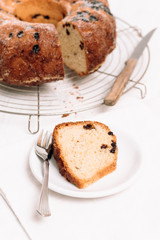 Slice of traditional German or Austrian Gugelhupf or Kouglof from Alsace, France, a round bundt cake with raisins made of brioche yeast sponge or sweet bread dough and dusted with sugar