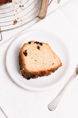 Slice of traditional German or Austrian Gugelhupf or Kouglof from Alsace, France, a round bundt cake with raisins made of brioche yeast sponge or sweet bread dough and dusted with sugar