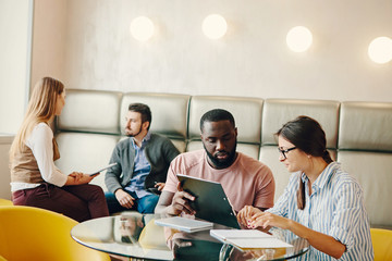Young people work in light office.
