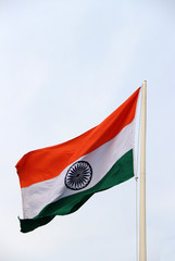 Tri Color of Indian Flag, Orange white and green color with blue Dhamma wheel at center on sky background. Blown away by wind.