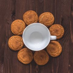 Cup of coffee and oatmeal cookies on wooden background. Top view