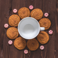 Cup of coffee, oatmeal cookies and candy on wooden background Top view