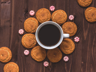 Cup of coffee, oatmeal cookies and candy on wooden background Top view