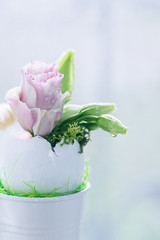 Eustoma flowers in an egg-shell on a light background