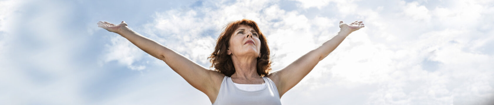 50s Yoga Woman Opening Up Arms To Exercise, Practicing Meditation