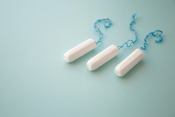 Menstrual tampon on a blue background top view. place for text. 