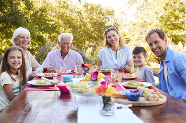 Three generation family having lunch in the garden