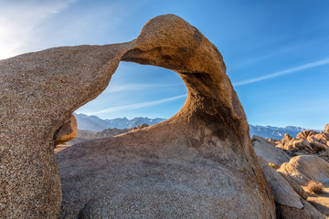 Mobius Arch on sunset with Whitney mountain on background. Alabama Hills, Eastern Sierra Nevada Mountains, Lone Pine, California, USA.