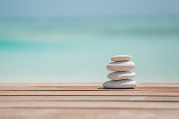 Zen stones on relaxing beach background. Calmness and motivational background design