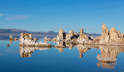 Sunset at Mono lake, California. Bizarre calcareous tufa formation on the smooth water of the lake.