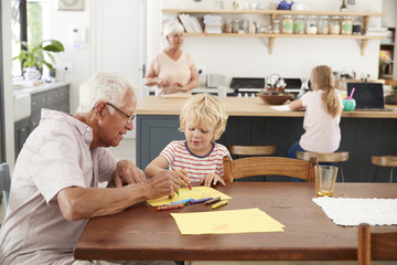 Grandparents and grandkids in family kitchen, close up