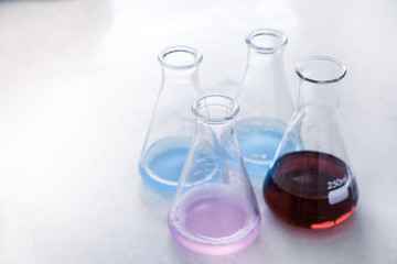 Group of glassware scientific equipment in chemical laboratory, that is a erlenmeyer flask with chemicals.