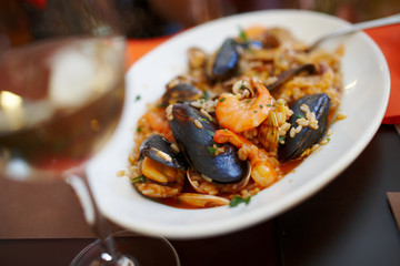 a plate of rice with seafood