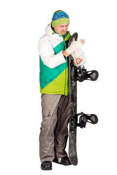 Full length portrait of young man in sportswear with snowboard isolated on a white background. Sport and people concept.