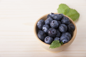 Berries of blueberry  in a wooden bowl
