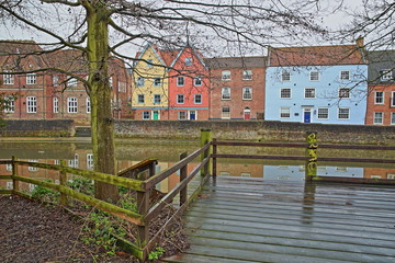 The riverside (river Wensum) in Norwich (Norfolk, UK) with reflections of colorful houses 