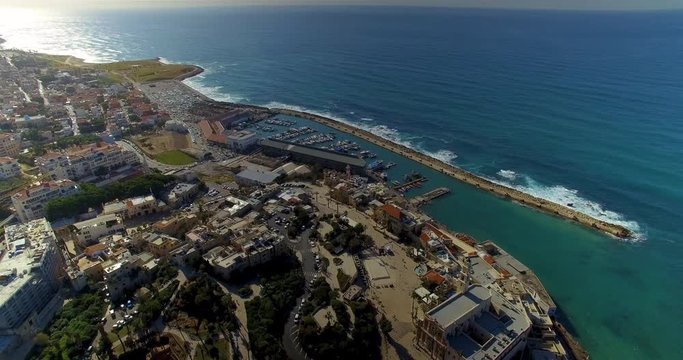 Aerial shot over Tel Aviv panning from the shoreline to the city