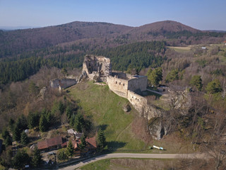 Fototapeta na wymiar Kamenets, near Odjykon, Poland -april 8, 2018: Ancient ruins of a medieval castle against the backdrop of a natural landscape of the central strip of central Europe. View of drone. Panorama of fly.