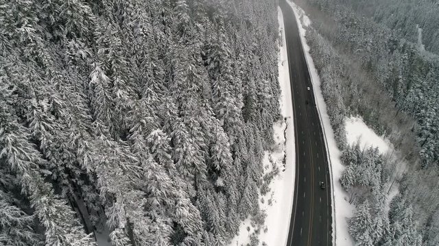 Flying Over Mountain Highway in Winter Weather