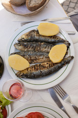 Restaurant. Fried fish with boiled potatoes on a white plate. Fish day