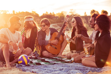 Young group of friends outdoors on the beach