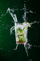 fresh mojito drink with liquid splash and crushed ice in freeze motion.