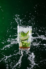 fresh mojito drink with liquid splash and crushed ice in freeze motion.