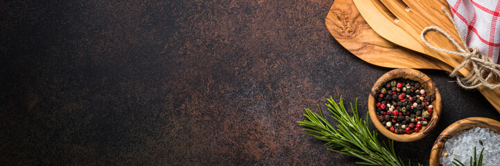Cooking utensils with spices and herbs top view. © nadianb
